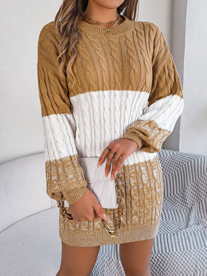 Colorblock cable knit mini dress in camel and white acrylic with crew neck and long sleeves.