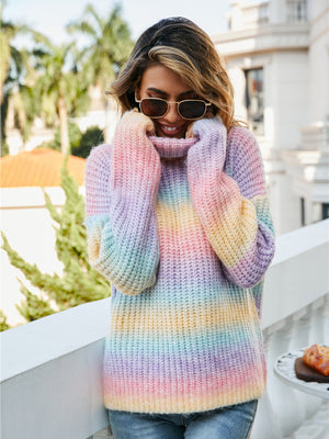 Chunky knit turtleneck sweater with rainbow gradient stripes and a cozy acrylic blend.
