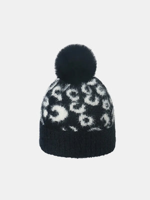 Black and white leopard print knit beanie with a black pom pom.