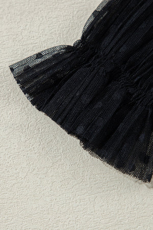 Black sheer mesh blouse with textured dot pattern and ruched detail.