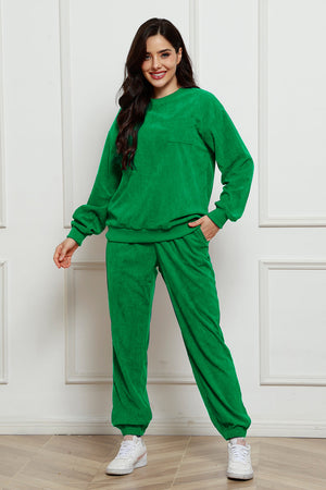 Green corduroy lounge set with crew neck sweatshirt and pocket, and matching pants.