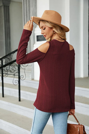Textured knit cold-shoulder top in wine with long sleeves and a casual cut.