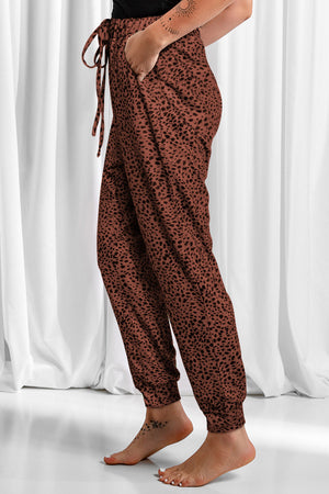 Brown leopard print joggers with drawstring waist and cuffed ankles.