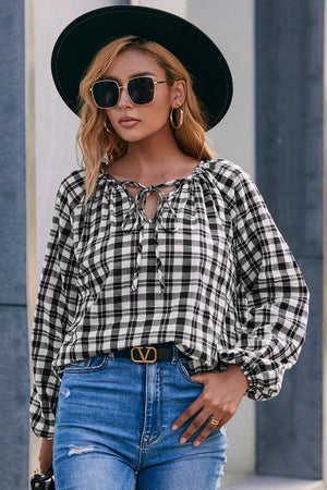 Black and white gingham blouse with gathered neckline and tie detail, balloon sleeves.