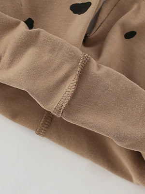 Brown cotton baby set with black wildcat spots and visible stitching detail.