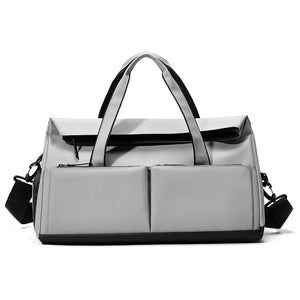 Grey nylon travel duffel bag with multiple exterior pockets and black trim.