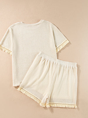 Cream waffle knit outfit set with fringe trim on short sleeves and hem.