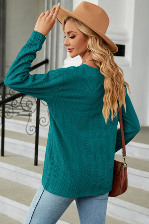 Textured cable-knit henley pullover in turquoise with long sleeves and a crew neck.