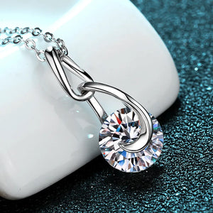 Silver solitaire pendant necklace with a round-cut crystal and a twisted bail.