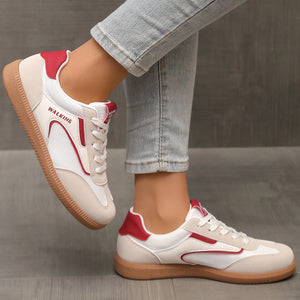 White and red lace-up sneakers with tan soles and "WALKING" text detail.