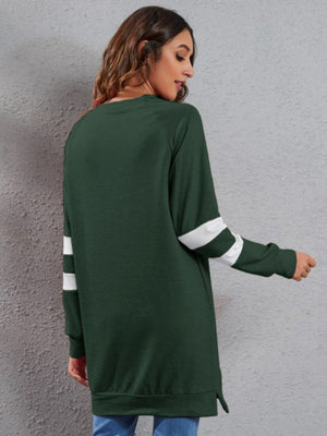 Dark Green sweatshirt dress with white varsity stripes on the sleeves.