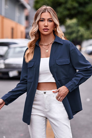 Dark blue oversized utility shirt with two chest pockets and button cuffs.