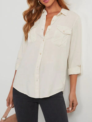 Washed denim utility shirt in white with two chest pockets and buttoned cuffs.