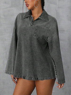 Oversized dark denim polo shirt with a quarter zip, collared neckline, and chest pocket.