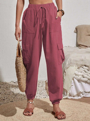 Textured cargo lounge trousers in dusty pink with drawstring waist and cuffed ankles.