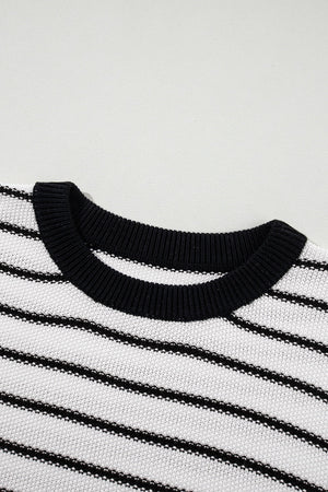 Black and cream striped knit sweater with contrast trim neckline.