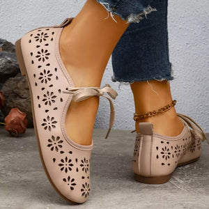 Apricot floral cutout slip-on flats with tie ankle straps.