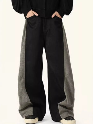 Men's black sweatpants with grey contrast panels and relaxed fit