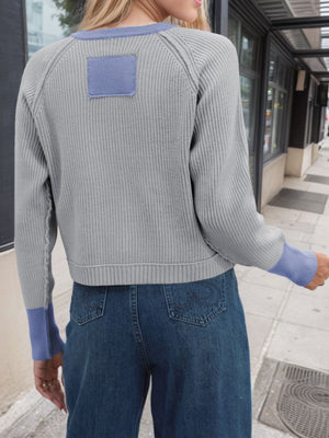 Gray raglan sleeve knit cardigan with blue accents and patch detail