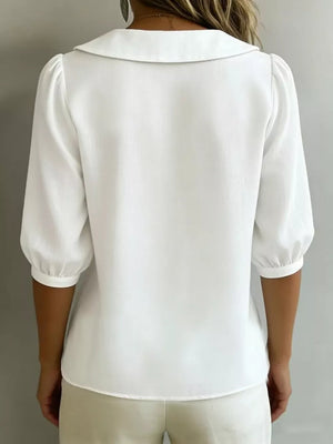 White puff sleeve shirt with Peter Pan collar and button-down detail.