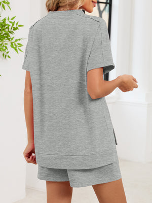 Gray relaxed two-piece set with short sleeves, crew neck, and side slit shorts with pockets.