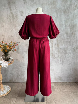 Deep red textured tie-front crop top with balloon sleeves and wide-leg pants set.