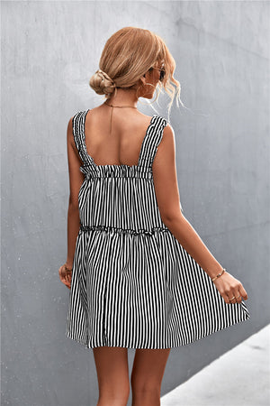 Black and white striped mini dress with ruffle yoke and tiered skirt.