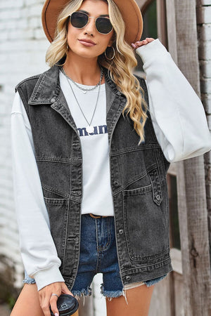Dark denim vest with button front and chest pockets, worn over a white sweatshirt.