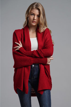 Red acrylic cocoon knit sleeve cardigan with open front and textured sleeves.
