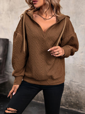 Chestnut cable knit hooded pullover with textured diamond pattern and v-neck.