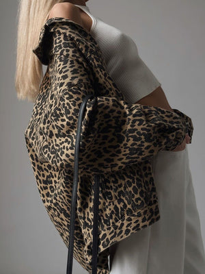 Oversized leopard print denim jacket with button details and a collar.
