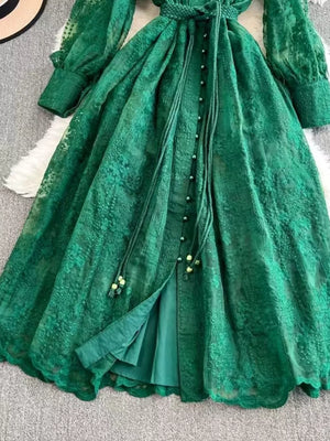 Green lace maxi dress with balloon sleeves, tie waist, and button-down front.