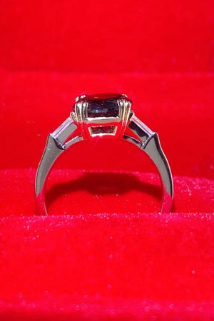 Black moissanite solitaire ring with baguette accents in sterling silver.