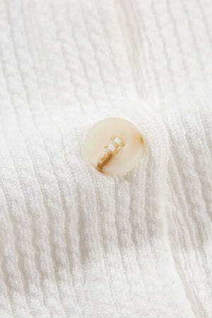White textured corduroy overshirt with a marbled button detail.