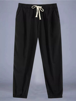 Black relaxed fit drawstring sweatpants with ankle cuffs and pockets.