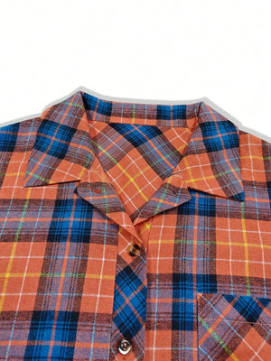 Oversized orange plaid shacket with a relaxed fit, featuring a collar and button front.