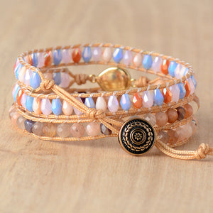 Multicolor gemstone and bead wrap bracelet with gold clasp and decorative button.