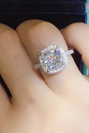 White gold cushion-cut halo engagement ring with a large center stone.