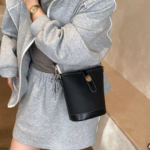 Bucket Leather Crossbody Bag in Black, model styling view