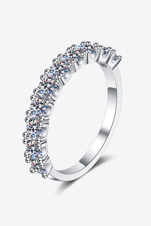 Silver eternity band ring with a row of brilliant moissanite stones.