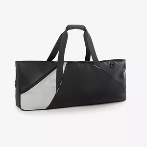 Modern color block travel bag in black with a silver panel and dual handles.