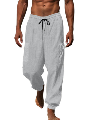 Light gray waffle knit joggers with drawstring and cargo pockets.