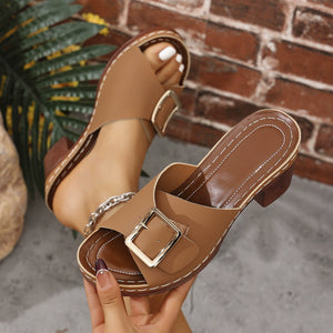 Tan block heel sandals with buckle detail and open toe.