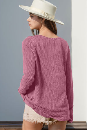Pink waffle knit henley shirt with thumbhole cuffs and a relaxed fit.