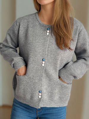 Gray ribbed knit button-up cardigan with pastel colored buttons and pockets.