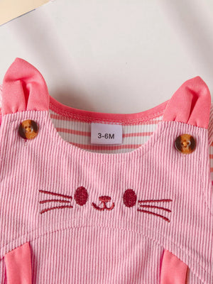 Pink corduroy baby dress with cat face embroidery and striped sleeves.