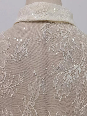 Floral lace dress detail with sequins on collar and back.
