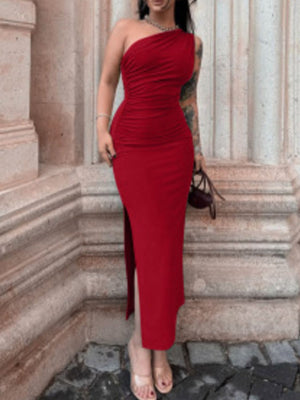 Deep red one-shoulder ruched bodycon dress with a high slit and subtle necklace.