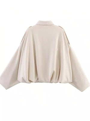 Oversized off-white zip-up jacket with a collared neckline and cinched hem.