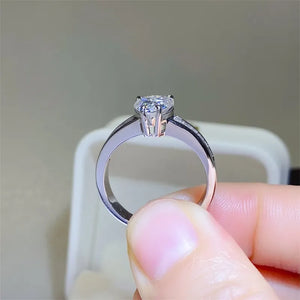 Silver pear cut moissanite ring with baguette accents